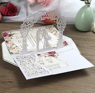 a wedding card with a couple of people standing in front of a bouquet