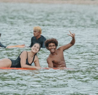 happy surfers in the water