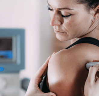 Laser therapy. Physical therapist treating patient's shoulder