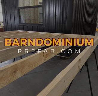 Standard Stud Wall with Black Mini Barndominium in the background