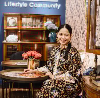 a woman sitting at a table with a tray of food