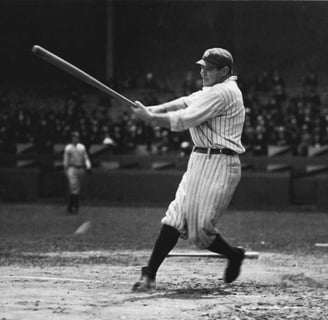 Babe Ruth swinging bat in classic black and white photo