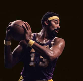 Wilt Chamberlain holding basketball, dark background