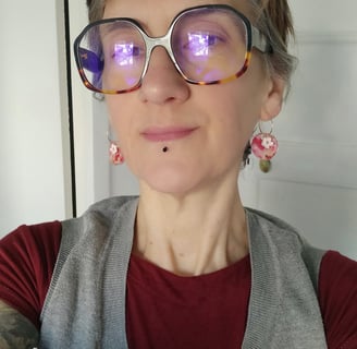 a woman with glasses and a red shirt