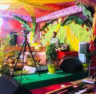 a man playing a keyboard in a brightly colored stage