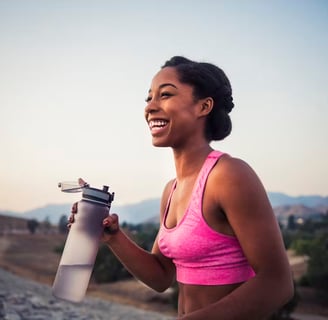 Women in sports clothes holding a water bottle, sports photography