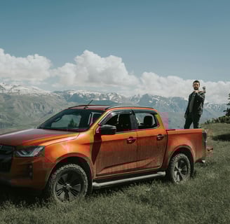 Orange Suzuki Pick-Up against mountain brackgraund