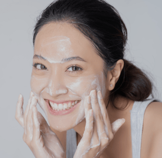 Young woman washing her face