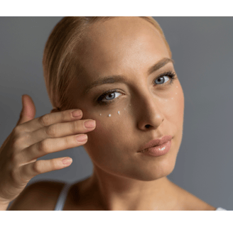 Woman applying eye cream to help prevent bags under eye and fine lines