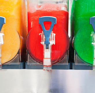 a bunch of different colored drinks in a row