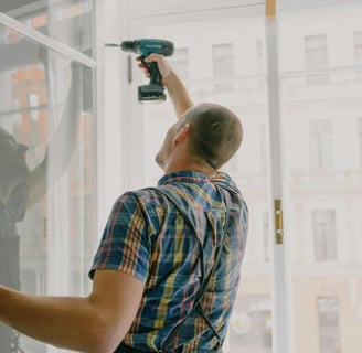 a handyman is holding a drill and a cordless cordless drillet