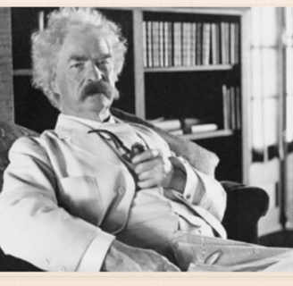 a man in a suit and tie sitting on a couch