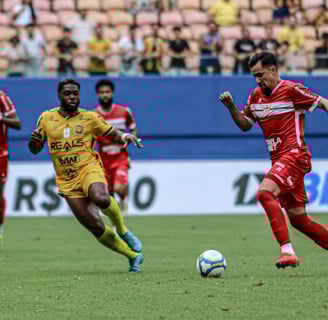 a soccer player is running with the ball
