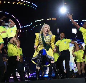 a woman in a yellow dress and a man in a yellow shirt and black pants