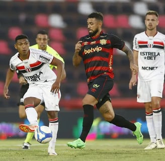 a soccer player is running with the ball