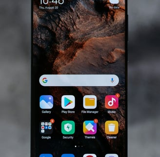 a close up of a smartphone with a phone in the background