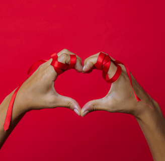 a person holding their hands in a heart shape
