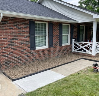 Rock bed landscaping around home