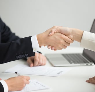 pharmacovigilance experts concluding a pharmacovigilance agreement and shaking hands