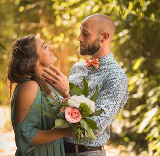 a man and woman standing in front of a tree