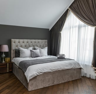 Cozy bed with throw pillows and a soft blanket for comfort.