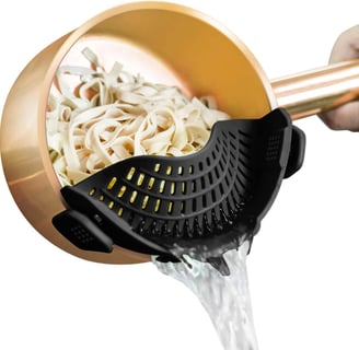 Clip-on pot strainer for easy pasta and vegetable draining, perfect for small kitchens.