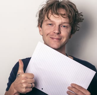 Smiling man making a positive gesture to symbolize motivation and confidence