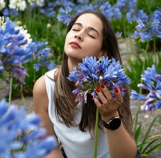 a woman is holding a flower in front of a flower