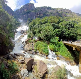Rawana Waterfall near Ella, Sri Lanka, cascading down rocky cliffs surrounded by lush greenery
