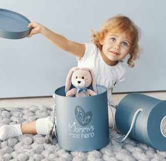 Cute and gentle Logo and Brand Identity for baby store Mommy's Hero, gift box, happy girl
