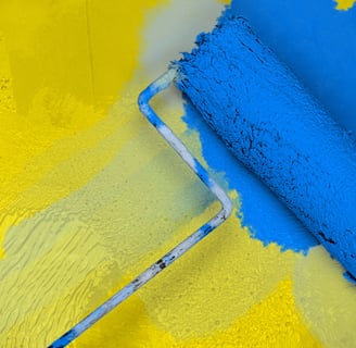 blue paint roller on yellow wall