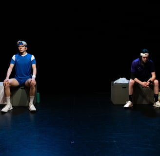 The Last Match - Two actors (one stiff, one hunched) sitting on blocks, separated by darkness