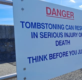 Danger Sign that says "Tombstoning can result in serious injury or death Think before you jump"