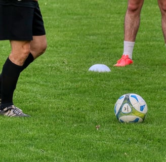 a soccer player is kicking a soccer ball