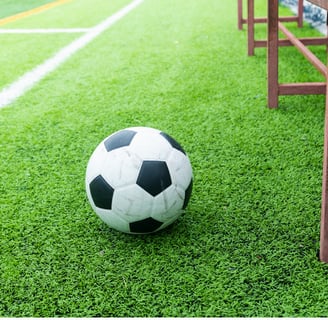 a soccer ball on the grass in a soccer field