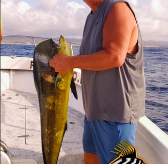 a man holding a fish fish on a boat