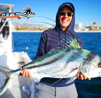 a man holding a fish fish on a boat