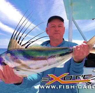 a man holding a fish fish on a boat