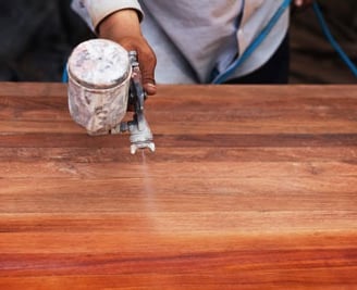 a person using a grinder on a wooden table