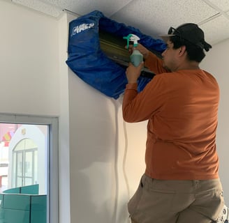 a man in a orange shirt is holding a blue bag