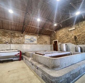 a stone wall with a stone bathtub and a stone wall