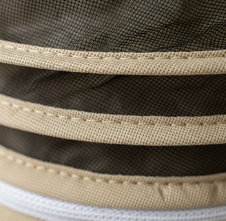 Detailed stitching and ventilated mesh layers in a premium bee suit.