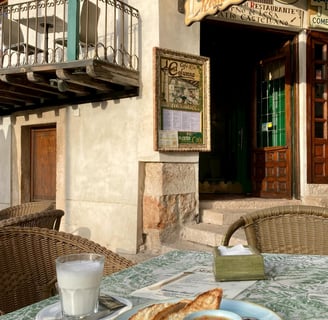 a table with a plate of food and a cup of coffee