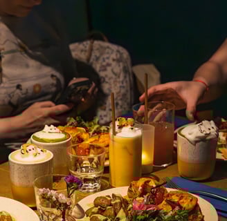 a table with plates of food and drinks