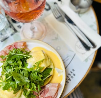 a plate of food with a glass of wine and a glass of wine