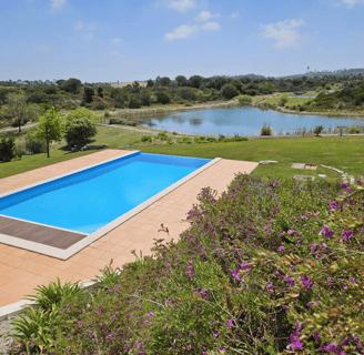 a pool with a view of a pond and a pond