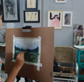 Student painting a watercolor in painting class