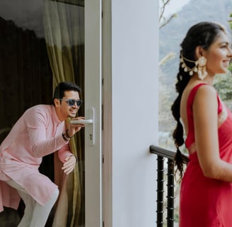 bride and groom getting fun standing on a balcony before marriage