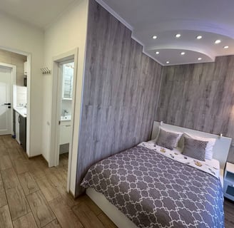 a bedroom with a bed and a bed in the middle of a room
