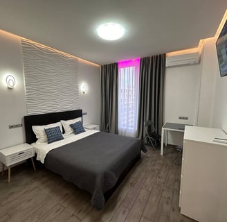 a bedroom with a bed and a television